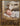 Gabriel Heaton painting of the baby Jesus sleeping in a golden straw manger with a white lamb resting beside him in soft warm light