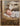 Gabriel Heaton painting of the baby Jesus sleeping in a golden straw manger with a white lamb resting beside him in soft warm light