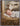 Gabriel Heaton painting of the baby Jesus sleeping in a golden straw manger with a white lamb resting beside him in soft warm light