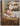 Gabriel Heaton painting of the baby Jesus sleeping in a golden straw manger with a white lamb resting beside him in soft warm light