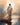 Gabriel Heaton painting of Jesus Christ seen from behind walking into brilliant white light reflected in calm water surrounded by dramatic clouds