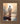 Gabriel Heaton painting of Jesus Christ seen from behind walking into brilliant white light reflected in calm water surrounded by dramatic clouds