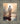 Gabriel Heaton painting of Jesus Christ seen from behind walking into brilliant white light reflected in calm water surrounded by dramatic clouds