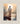 Gabriel Heaton painting of Jesus Christ seen from behind walking into brilliant white light reflected in calm water surrounded by dramatic clouds