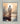 Gabriel Heaton painting of Jesus Christ seen from behind walking into brilliant white light reflected in calm water surrounded by dramatic clouds