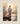 Gabriel Heaton painting of Jesus Christ seen from behind walking into brilliant white light reflected in calm water surrounded by dramatic clouds