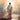 Gabriel Heaton painting of Jesus Christ seen from behind walking into brilliant white light reflected in calm water surrounded by dramatic clouds