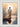 Gabriel Heaton painting of Jesus Christ seen from behind walking into brilliant white light reflected in calm water surrounded by dramatic clouds