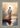 Gabriel Heaton painting of Jesus Christ seen from behind walking into brilliant white light reflected in calm water surrounded by dramatic clouds