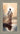 Gabriel Heaton painting of Jesus Christ seen from behind walking into brilliant white light reflected in calm water surrounded by dramatic clouds